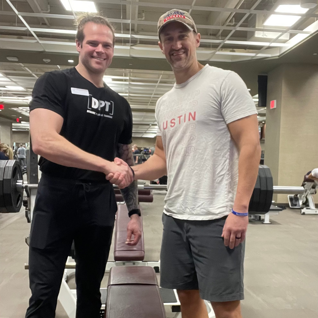 Two trainers doing bicep curls together