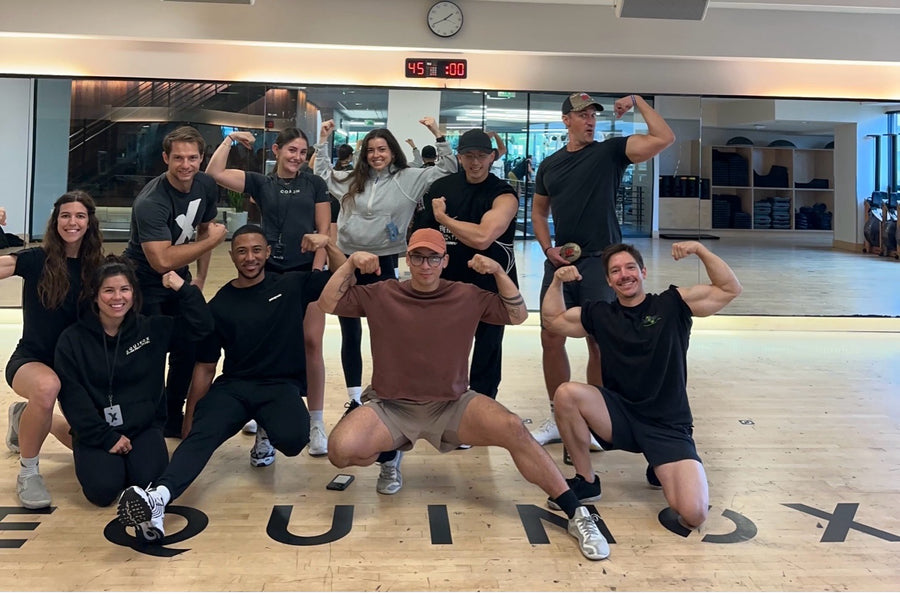 Trainees flexing together in an Equinox studio
